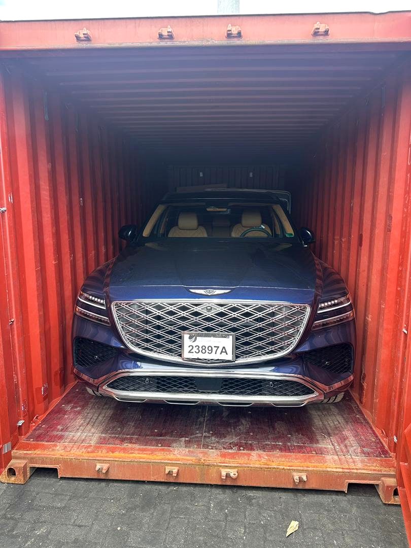 Premium Genesis vehicle secured inside a shipping container for clearance at Tema Port by 7AS Trust