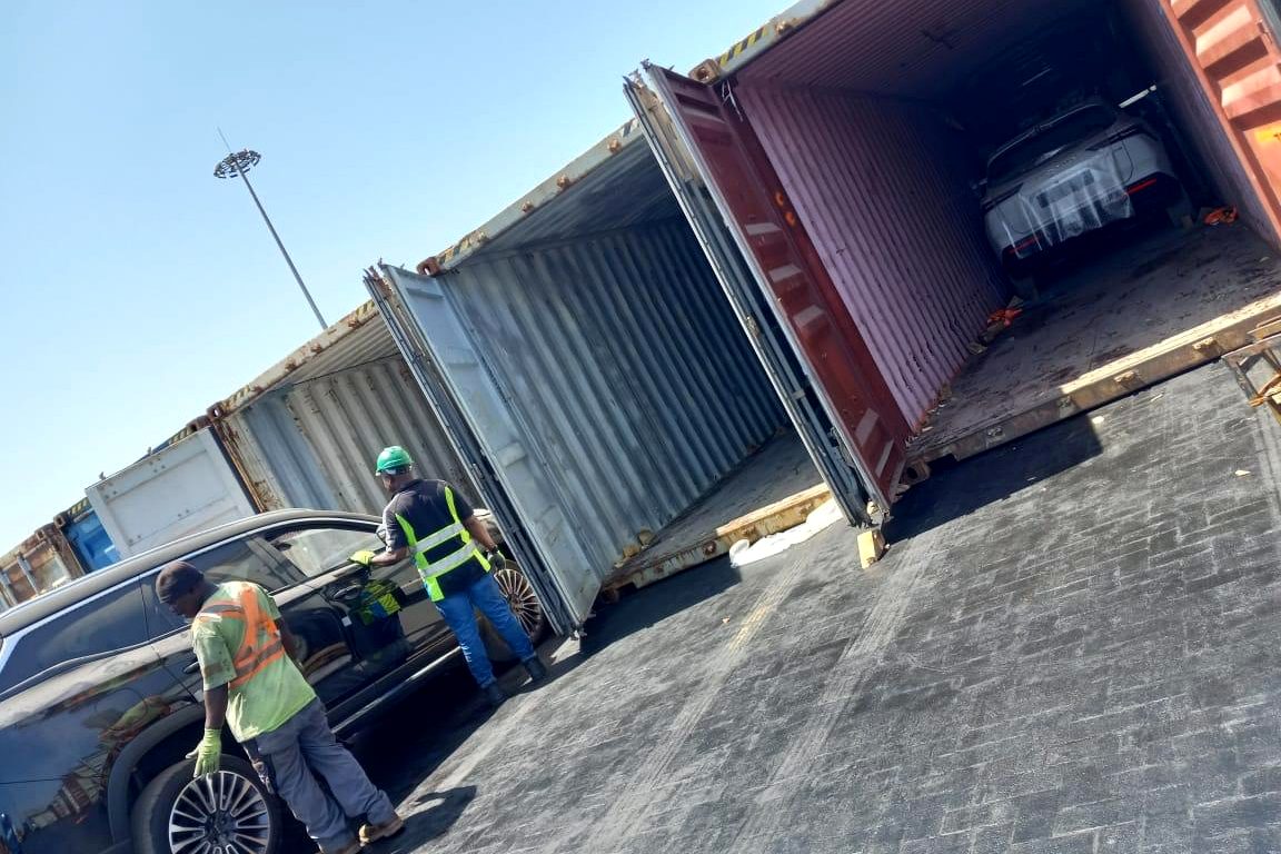 7AS Trust team unloading an imported SUV from a shipping container at Tema Port, Ghana