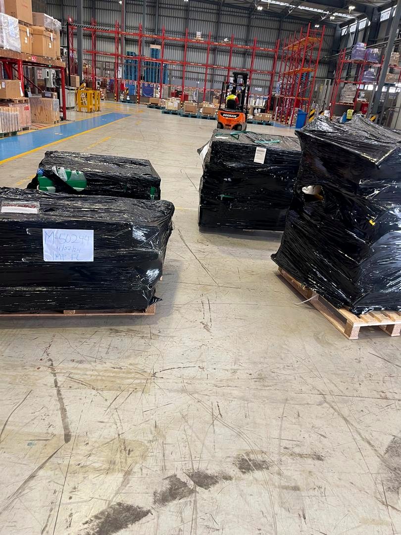 Palletised and stretch-wrapped cargo in a Ghana warehouse ready for distribution by 7AS Trust
